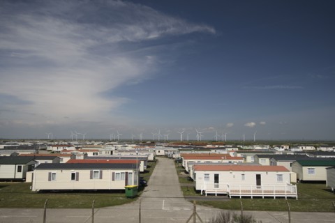 England, Kent, Romney Marshes, Old Romney  view over Camber holiday caravan park toward distant