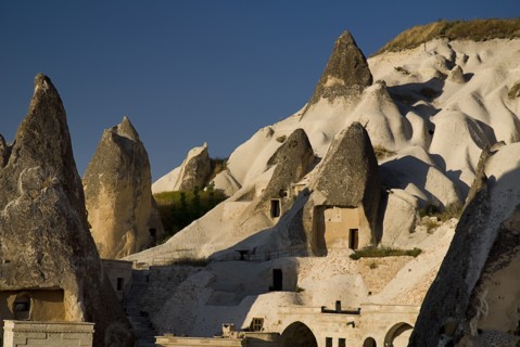 Peaked rooftops of cave dwellings set into volcanic tufa of hillside. Photo: Hugh Rooney