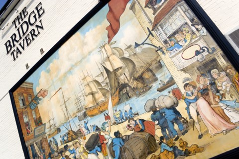 The Camber in Old Portsmouth showing the Bridge Tavern mural of Thomas Rowlansons cartoon titled