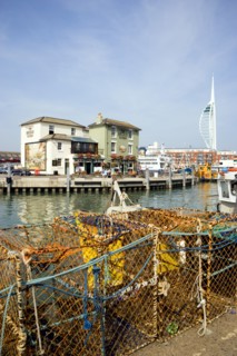 The Camber in Old Portsmouth showing the Spinnaker Tower behind the Bridge Tavern with its mural of