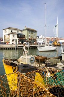 The Camber in Old Portsmouth showing the Spinnaker Tower behind the Bridge Tavern with its mural of