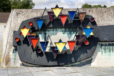 Dachau World War II Nazi Concentration Camp. Prisoner badges memorial Communists were given red