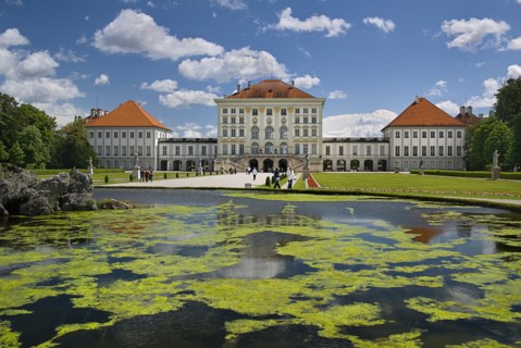 Nymphenburg Palace. Baroque exterior facade set in formal gardens with lake in foreground. Photo: