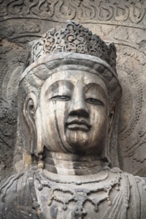 Carved Buddha statue in the Fengxian Temple Tang Dynasty Longmen Grottoes and Cave. Photo : Mel