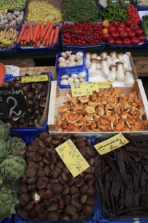 Vegetable stall in the Naschmarkt. Cropped view of display of produce including mushrooms hazelnuts