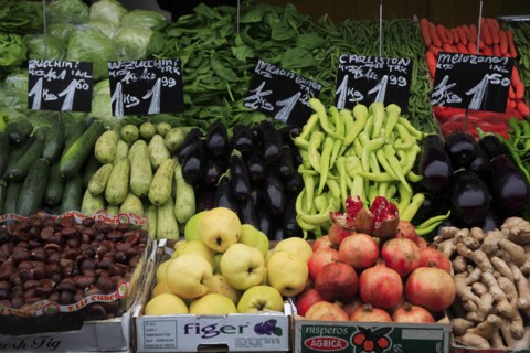 Fruit and vegetable stall in the Naschmarkt with display of produce including hazelnuts aubergines