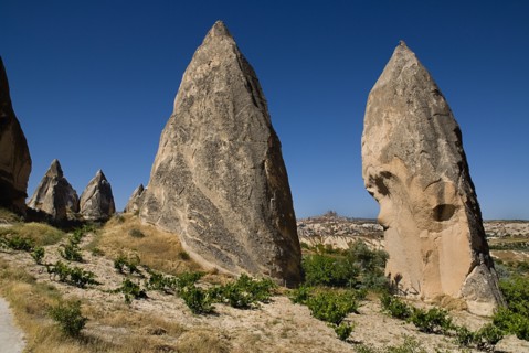 Sword Valley rock formations with hilltop town of Uchisar in distance behind. The valley got its
