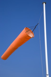 Orange wind-sock blowing in the wind indicating wind direction and strength. Photo : Paul Seheult