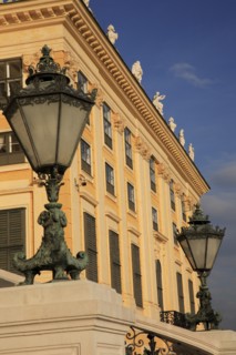 Schonnbrunn Palace. Part view of exterior facade with decorative metal lanterns on balcony in