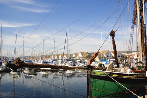 Port Solent Sailing barge SB Kitty moored in the marina with yachts and housing beyond. Photo: Paul