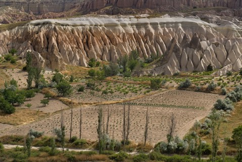 View across Rose Valley in foreground towards Red Valley behind. Cultivated land and eroded peaks