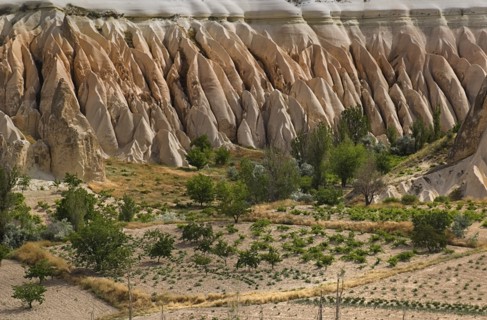 View across Rose Valley in foreground towards Red Valley behind. Cultivated land and eroded peaks