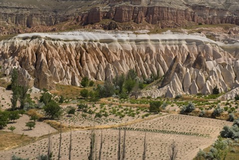 View across Rose Valley in foreground towards Red Valley behind. Cultivated land and eroded peaks