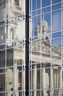 The Guildhall reflected in the windows of the Civic Offices. Originally built in 1890 but rebuilt