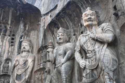 Carved Buddhist statues Fengxian Temple Tang Dynasty Longmen Grottoes and Caves. Photo : Mel