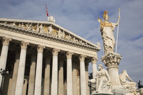 Statue of Athena set on pillar rising above fountain in front of Parliament building. Photo :