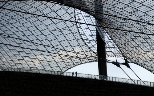 Olympic Stadium built as the main venue for the 1972 Summer Olympics. Pair of tourists silhouetted
