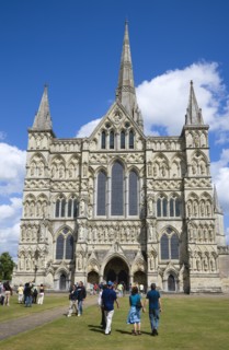 People on the grass of the Close in front of the West Front main entrance of the 13th Century Early