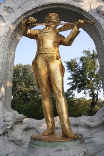 Statue of Johann Strauss in the Stadt Park framed by stone arch. Photo: Bennett Dean