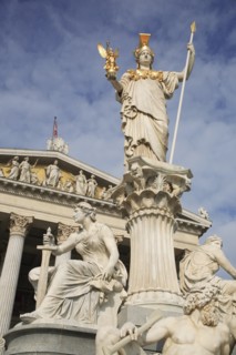 Statue of Athena elevated on column above fountain in front of the Parliament building. Photo: