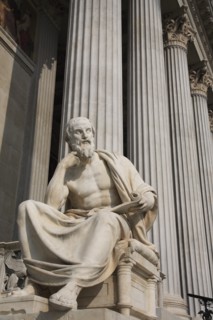 Statue of the Greek philosopher Herodotus in front of columns of the Parliament Building. Photo: