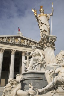 Statue of Athena raised on pillar above fountain in front of the Parliament building. Photo :