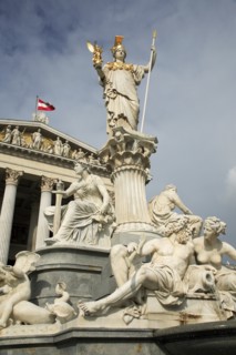 Statue of Athena raised on pillar above fountain in front of the Parliament building. Photo :