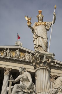 Statue of Athena raised on pillar above fountain in front of the Parliament building. Photo :