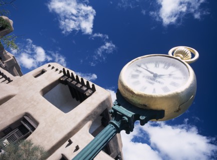 Museum with typical Adobe architecture and large clock in the foreground. Photo : Stephen Rafferty