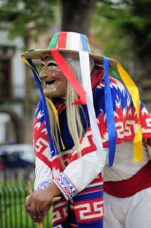 Mexico, Michoacan, Patzcuaro, Figure dressed in mask and costume for performance of Danza de los