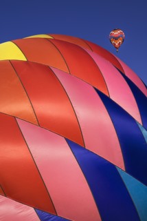 USA, New Mexico, Albuquerque, Annual balloon fiesta colourful hot air balloons with part view of