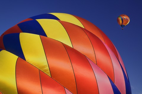 USA, New Mexico, Albuquerque, Annual balloon fiesta colourful hot air balloons with part view of