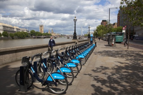 England, London, Vauxhall. Albert Embankment of the river Thames man buying time on bicycle hire