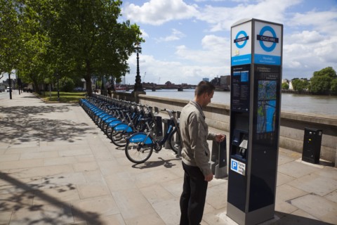 England, London, Vauxhall Albert Embankment of the river Thames man buying time on bicycle hire