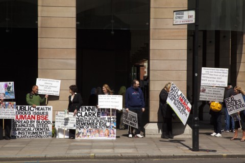 England, London, Westminster Protesters campaigning with placards outside the Houses of Parliament.