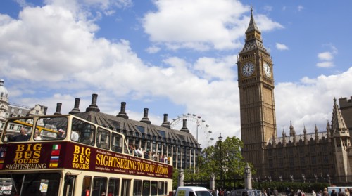 England, London, Westminster sight seeing bus with tourists passing by the Houses of Parliament