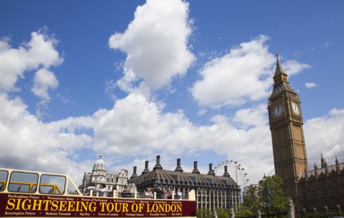 England, London, Westminster sight seeing bus with tourists passing by the Houses of Parliament