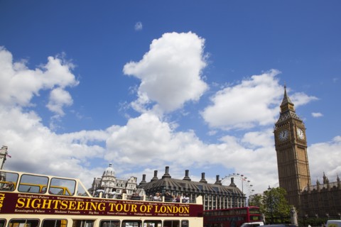 England, London, Westminster sight seeing bus with tourists passing by the Houses of Parliament