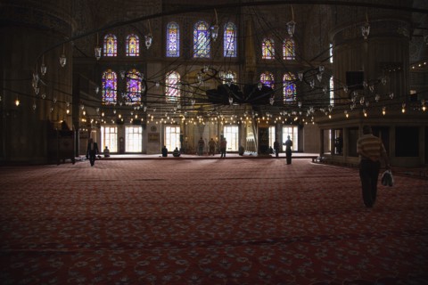 Turkey, Istanbul, Sultanahmet Camii Blue Mosque interior with men at worship. 
Photo : Stephen