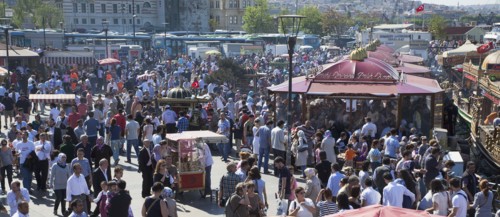 Turkey, Istanbul, Eminonu busy square with food stall on the Golden Horn next to Galata Bridge.
