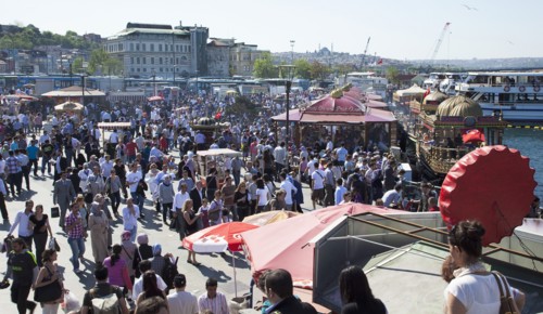 Turkey, Istanbul, Eminonu busy square with food stall on the Golden Horn next to Galata Bridge.