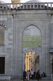 Turkey, Istanbul, Sultanahmet Camii The Blue Mosque with people passing through the entrance to the