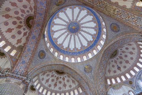 Turkey, Istanbul, Sultanahmet Camii The Blue Mosque interior with decorated painted domes. 
Photo