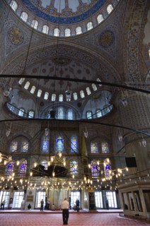 Turkey, Istanbul, Sultanahmet Camii The Blue Mosque interior with people at prayer beneath