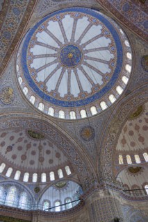 Turkey, Istanbul, Sultanahmet Camii The Blue Mosque interior with decorated painted domes. 
Photo