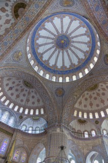 Turkey, Istanbul, Sultanahmet Camii The Blue Mosque interior with decorated painted domes. 
Photo