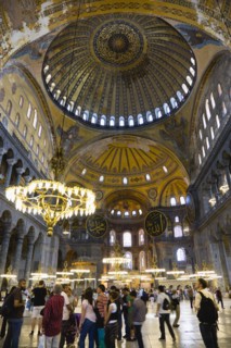 Turkey, Istanbul, Sultanahmet Haghia Sophia Sightseeing tourists beneath the dome with murals and