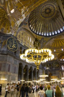 Turkey, Istanbul, Sultanahmet Haghia Sophia Sightseeing tourists beneath the dome with murals and