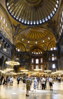 Turkey, Istanbul, Sultanahmet Haghia Sophia Sightseeing tourists beneath the dome with murals and