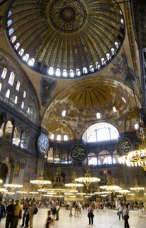 Turkey, Istanbul, Sultanahmet Haghia Sophia Sightseeing tourists beneath the dome with murals and